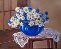 Still life with daisies in a blue vase.
