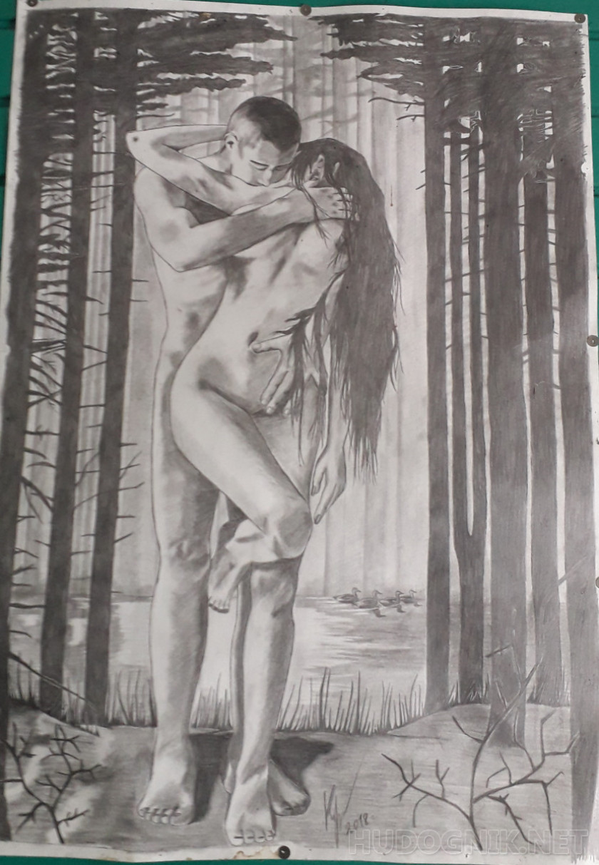 A girl and a young man kiss in the forest