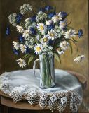 Daisies and cornflowers in a glass mug