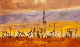 Нефтяные вышки на фоне гор